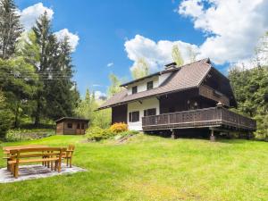 a house with a bench in front of it at Chalet in Gnesau in Carinthia with sauna in Gnesau