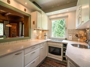 a kitchen with white cabinets and a sink and a window at Chalet in Gnesau in Carinthia with sauna in Gnesau