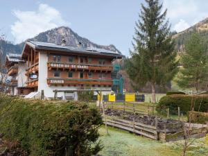 a large building with a fence in front of it at Apartment in Wald near Zillertal Ski Slopes in Wald im Pinzgau