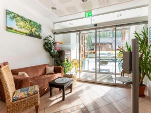 a living room with a couch and a tv at Apartment in Wald near Zillertal Ski Slopes in Wald im Pinzgau