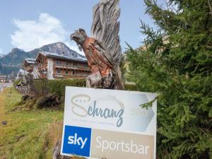 a statue of a bird sitting on top of a sign at Apartment in Wald near Zillertal Ski Area in Wald im Pinzgau