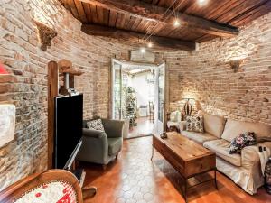 a living room with a brick wall at Charming holiday home in Lorgues with pool in Lorgues