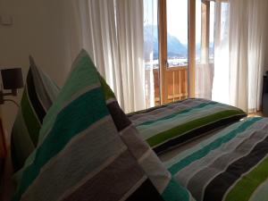 a bedroom with a bed and a window with a view at Haus Berglust Wallgau in Wallgau