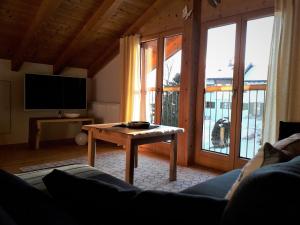 a living room with a couch and a table at Haus Berglust Wallgau in Wallgau