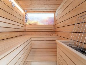 a wooden sauna with a window in it at Chalet in Saalbach near Ski Slopes in Saalbach-Hinterglemm