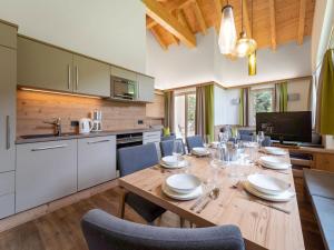 a kitchen and dining room with a wooden table and chairs at Chalet in Saalbach near Ski Slopes in Saalbach-Hinterglemm