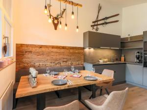 a dining room with a wooden table and chairs at Urbane Apartment in Kirchdorf in Tirol near Ski Area in Kirchdorf in Tirol