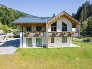 a house with a balcony with flowers on it at Chalet in Saalbach near Ski Slopes in Saalbach-Hinterglemm +32 photos