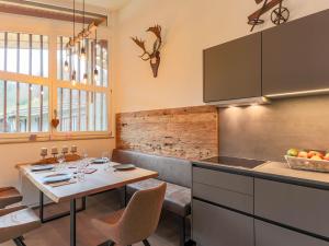 a kitchen with a table and a dining room at Urbane Apartment in Kirchdorf in Tirol near Ski Area in Kirchdorf in Tirol