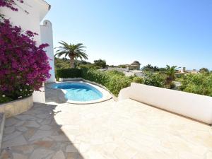 a backyard with a swimming pool and flowers at Belvilla by OYO Casa Patricia in Altea la Vieja