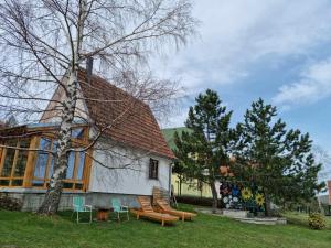 a building with a group of benches in front of it at Holiday house Zmajevac (Tornik, Zlatibor) in Zlatibor
