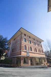 a large building on the corner of a street at Hotel PRime - Montecatini in Montecatini Terme