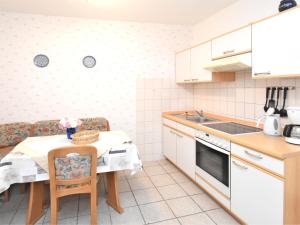 a small kitchen with a table and a sink at Spacious apartment in Harz near ski area in Blankenburg