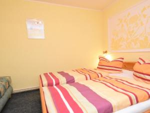 a bedroom with two beds and a painting on the wall at Spacious apartment in Harz near ski area in Blankenburg