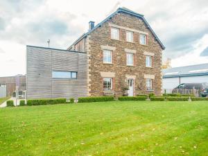 a large brick house with a large yard at Luxurious house with sauna in a farm in Bastogne in Bastogne
