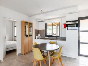 a kitchen and dining room with a table and chairs at Attractive Holiday Home in Malauc ne with Terrace in Malaucène