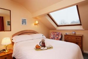 a bedroom with a large white bed with a window at Church Bank in Chapel Stile