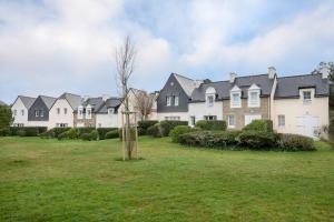 eine Reihe von Häusern in einem grünen Hof in der Unterkunft Face à la marina belle maison pour 6 in Arzon