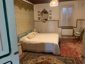 a bedroom with a bed and a table and a mirror at Fattoria Amelia in Santa Caterina