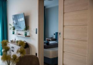 a room with a door leading to a bedroom with a bed at Marina Apartment by Dora in Keszthely
