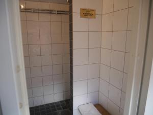 a bathroom with a shower with white tiles at SovPå Tåg i Tärnsjö in Tärnsjö