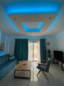 a living room with a blue ceiling at Golden Sand in Ammoudia