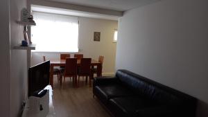 a living room with a couch and a dining room table at Fish house Sesimbra in Sesimbra