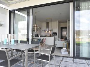 a dining room and living room with a table and chairs at Pleasant villa in Harderwijk with fenced garden in Zeewolde