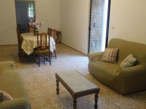 a living room with a couch and a table at Belvilla by OYO Aubergine in San Miguel de Balansat