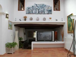 a living room with a television in a fireplace at Belvilla by OYO Can Pep Rustico in Sant Miquel de Balansat