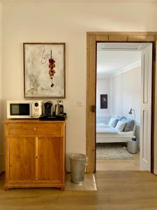 a living room with a microwave on a wooden cabinet at Beautiful studio in a villa from 18th century in Thun