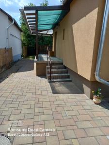 a walkway outside of a house with a stair case at Írisz Apartman in Mezőkövesd