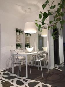 a dining room with a white table and chairs at Opis studio in Ornos