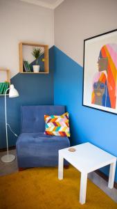 a living room with a blue couch and a table at People Hostel in Bishkek