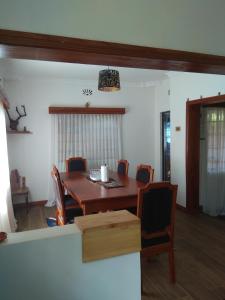 comedor con mesa de madera y sillas en Kwinet Luxury Villa en Eldoret