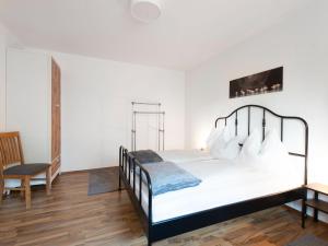 a bedroom with a bed and a desk and a chair at Apartment to the Zillertal near F gen in Bruck am Ziller