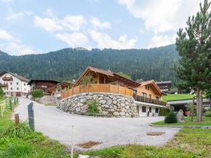 a house with a stone fence and a driveway at Apartment to the Zillertal near F gen in Bruck am Ziller