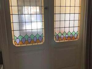 two doors with stained glass windows next to each other at Quietly located mansion near the centre of The Hague in The Hague
