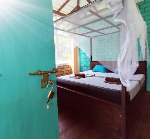 a bedroom with a canopy bed with a window at EKUKU lake houses in Kumbalgama