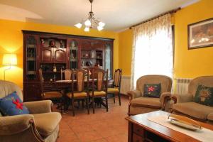 a living room with a dining table and chairs at Casa Rural El Carrascal in Casarejos