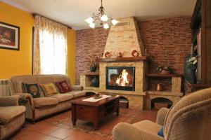 a living room with a couch and a fireplace at Casa Rural El Carrascal in Casarejos