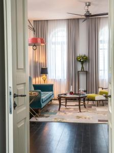 a living room with a couch and a table at The Norman Tel Aviv in Tel Aviv