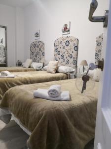 a group of three beds in a room at Big House Jerez in Jerez de la Frontera