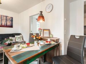 a dining room with a table with food on it at Bright apartment in a district of Ilmenau in Stützerbach