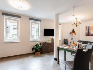 a living room with a table and a couch at Bright apartment in a district of Ilmenau in Stützerbach