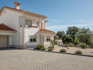 a large white house with a brick driveway at Wonderful villa in Ferreira do Zezere with private pool in Almogade