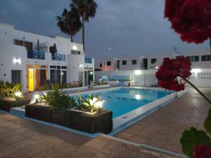 a villa with a swimming pool in front of a building at BLU in Puerto del Carmen
