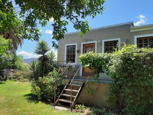 a house with a staircase in front of it at Karoo Life B&B in Calitzdorp