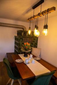 a dining room table with a vase of flowers and lights at Ferienwohnung Leit'n Heisl in Essing