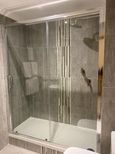 a bathroom with a shower stall and a tub at The City Hotel in Dunfermline